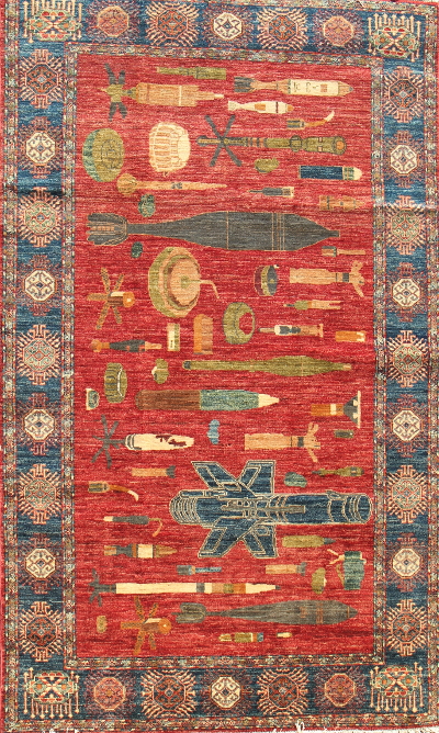 First example of Unexploded Ordnance Rugs: Small size, red field. 
 Afghan Rug